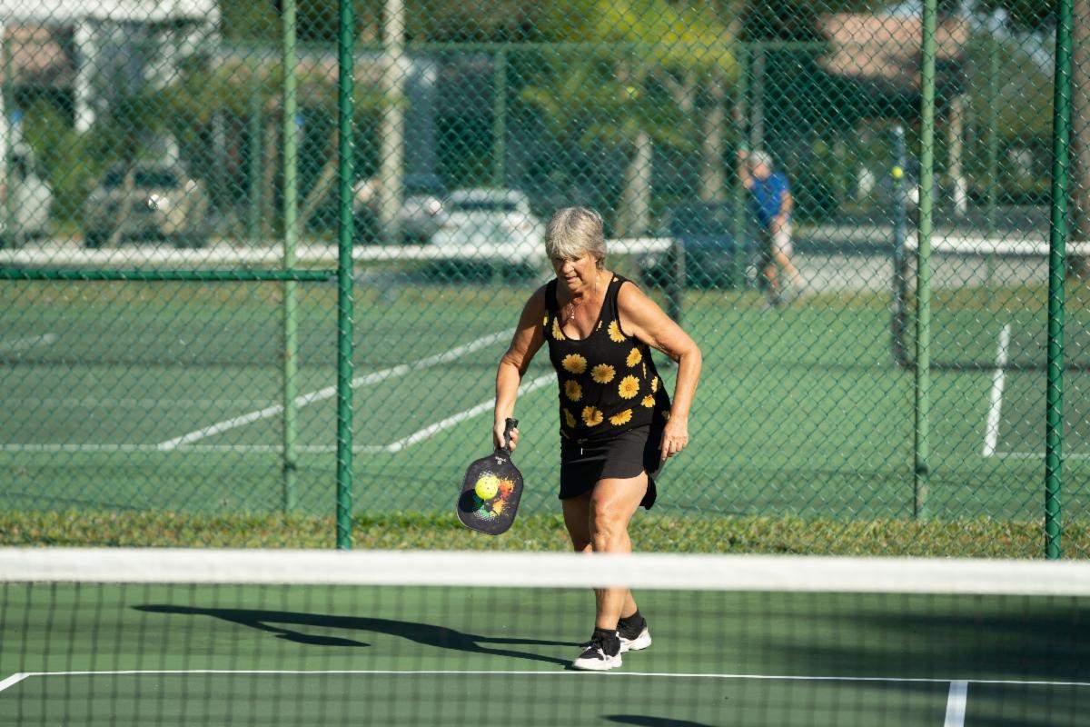 Resident playing tennis